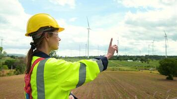 Close up engineering woman hand is touching virtual reality Analytics engineering data in a field over electrical turbines background video