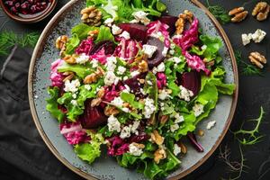 Salad with beet or beetroot, green mix lettuce, nuts, feta cheese. photo