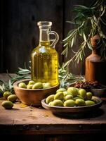 Glass container with olive oil on wooden table and olives. photo
