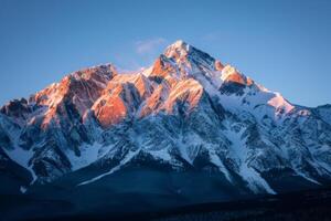 Majestic Snow Covered Mountain Under Blue Sky photo