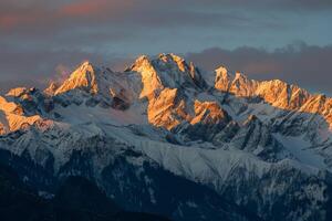 Snow Covered Mountain Range With Clouds photo