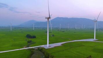 view of turbine green energy electricity, windmill for electric power production, Wind turbines generating electricity on rice field at Phan Rang, Ninh Thuan province, Vietnam video