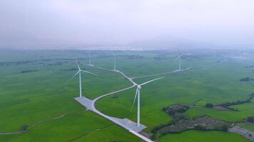 view of turbine green energy electricity, windmill for electric power production, Wind turbines generating electricity on rice field at Phan Rang, Ninh Thuan province, Vietnam video