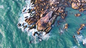 Aerial drone top view of beautiful waves crashing on the rocky island coast, ocean waves and fantastic. Ocean in Vietnam. video