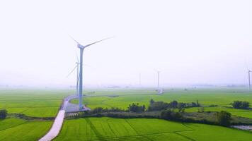 view of turbine green energy electricity, windmill for electric power production, Wind turbines generating electricity on rice field at Phan Rang, Ninh Thuan province, Vietnam video