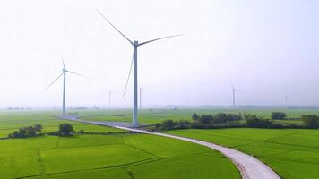 view of turbine green energy electricity, windmill for electric power production, Wind turbines generating electricity on rice field at Phan Rang, Ninh Thuan province, Vietnam video