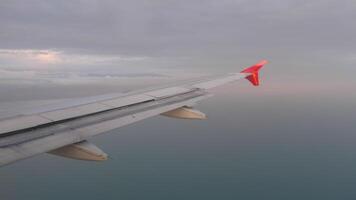 POV view from the window of an airplane in flight. Airliner wing. Airplane flying over the sea video