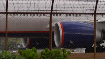 View of the landing gear and engine of an airliner. Airplane taxiing on the runway video