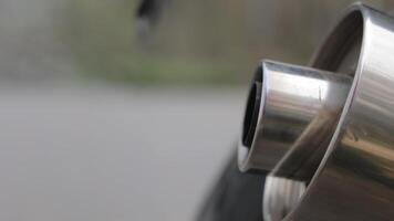 Air pollution with exhaust gases Close-up of a Polished Exhaust Pipe, A macro shot highlighting the gleam of a vehicle's exhaust pipe. video