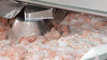 Industrial Food Mixer Grinding Meat and Ice, An industrial food mixer processing a blend of ground meat and ice, preparing the mixture for sausage making. video