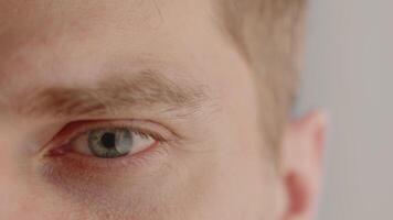 Close-up of the closed eye of a young man, which then opens and looks straight at the camera. Concept of vision of the future and hope for the best video