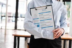 Close-Up of Businessman Holding a Resume. photo