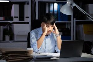 Businessman working overtime at his office He felt tired. photo