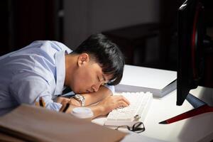 Businessman working overtime at his office He felt tired. photo