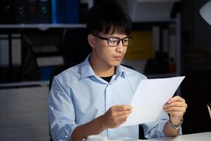 Businessman working overtime at his office He felt tired. photo