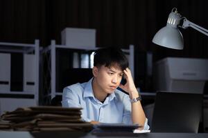 Businessman working overtime at his office He felt tired. photo