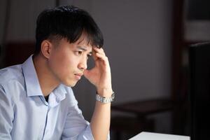 Businessman working overtime at his office He felt tired. photo