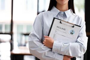 Close-Up of Businessman Holding a Resume. photo