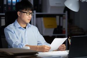 Businessman working overtime at his office He felt tired. photo