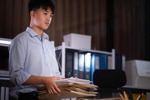 Businessman working overtime at his office He felt tired. photo