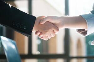 Two people shaking hands in a business setting photo