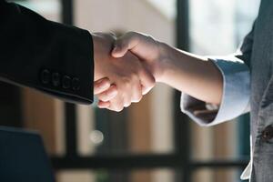 Two people shaking hands in a business setting photo