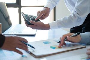 A team of business people is brainstorming to analyze investment project data. photo