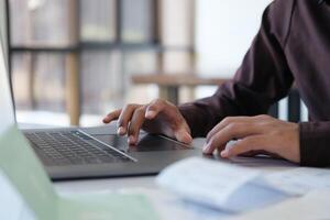 Accountant filling in items from a bill and use computers to calculate financial budgets photo