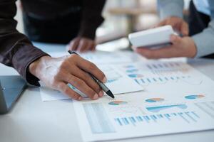 A team of business people is brainstorming to analyze investment project data. photo