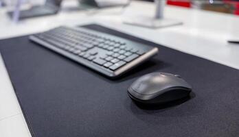 Computer mouse and keyboard on a mouse pad. Technology and IT concept. photo