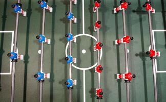 Table football. Green table with little players. Playing football table game. photo