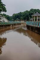 river water flowing fast after the rain with dirty brown water. photo