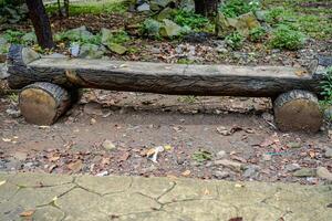 Park bench made of concrete in the shape of a wooden bar in a city park. photo