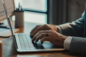 Corporate businessman in suit working on laptop in his office photo