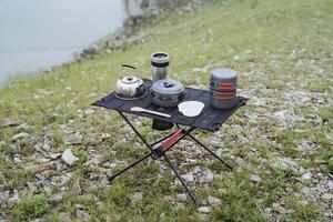 Top view of camping tableware, camping, camping camping table, mountain hiking, trekking in the mountains, lunch in the forest, table frame photo