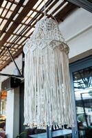 Wicker designer chandelier in the cafe, the interior of the street cafe, handmade, fabric cord for knitting, decor in the institution. photo