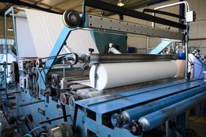 Greek factory for the production of paper rolls for hygiene. Manufacture of paper towels and toilet paper. Roll winding machine. photo