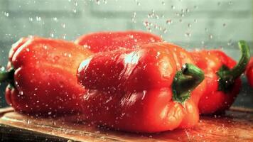 Drops of water fall on the sweet pepper. On a white background. Filmed is slow motion 1000 fps.High quality FullHD footage video