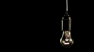 Super slow motion light bulb glows. On a black background.Filmed on a high-speed camera at 1000 fps.High quality FullHD footage video