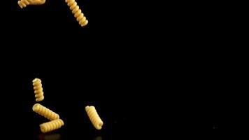 Super slow motion dry pasta falls. Filmed on a high-speed camera at 1000 fps. High quality FullHD footage video