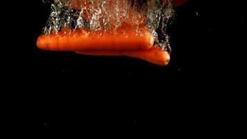 Super slow motion fresh carrots under water. High quality FullHD footage video