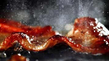 Super slow motion Bacon is fried in a pan. High quality FullHD footage video