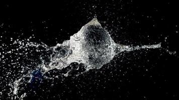 Super slow motion ball bursts with splashes of water. On a black background. Filmed on a high-speed camera at 1000 fps.High quality FullHD footage video