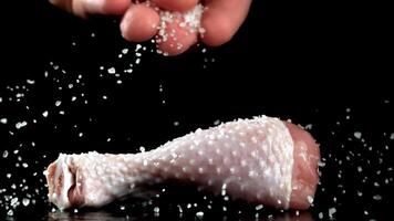 Super slow motion Sprinkle salt on the chicken legs. High quality FullHD footage video