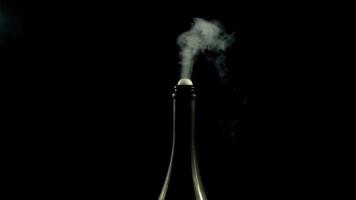 From the bottle rises up champagne with air bubbles. On a black background. Filmed is slow motion 1000 frames per second. High quality FullHD footage video