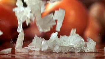 Super slow motion Sliced onion falls on the wet table. High quality FullHD footage video