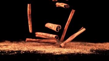 Super slow motion in a pile on the table falling cinnamon sticks. High quality FullHD footage video