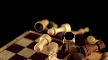 A collection of wooden chess pieces arranged on a dark background, reminiscent of an elegant event. The office equipment stands out against the blackness, creating a circle of contrast video