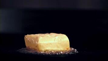 Super schleppend Bewegung ein Stück von Butter mit ein Gabel schmilzt im ein braten Pfanne. gefilmt auf ein schnelle Geschwindigkeit Kamera beim 1000 fps. hoch Qualität fullhd Aufnahmen video