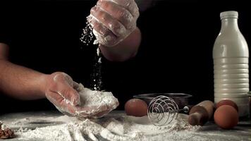 Super slow-moving men's hands cook baking at home. On a black background. Filmed on a high-speed camera at 1000 fps.High quality FullHD footage video